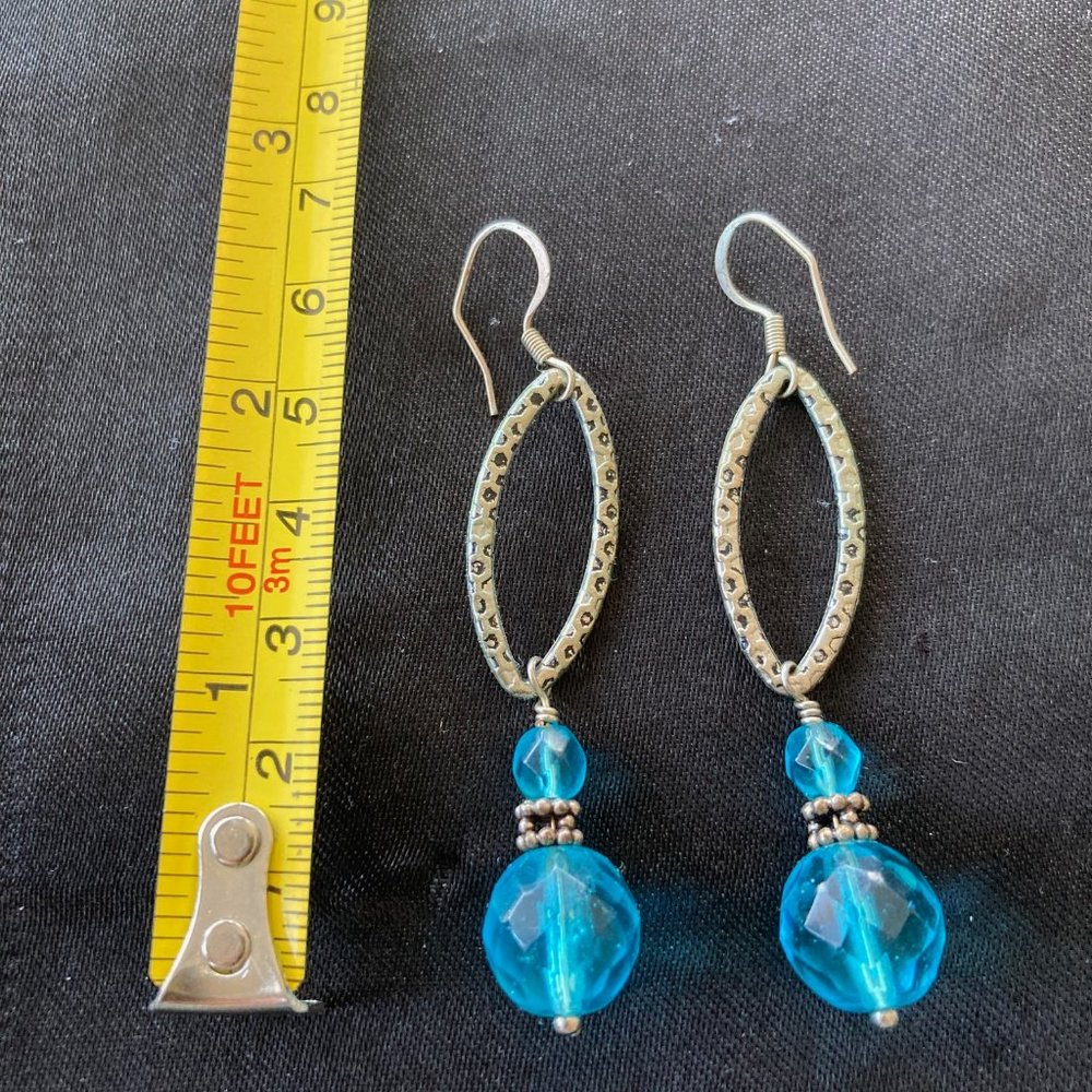 Silver looped long earrings with blue glass beads